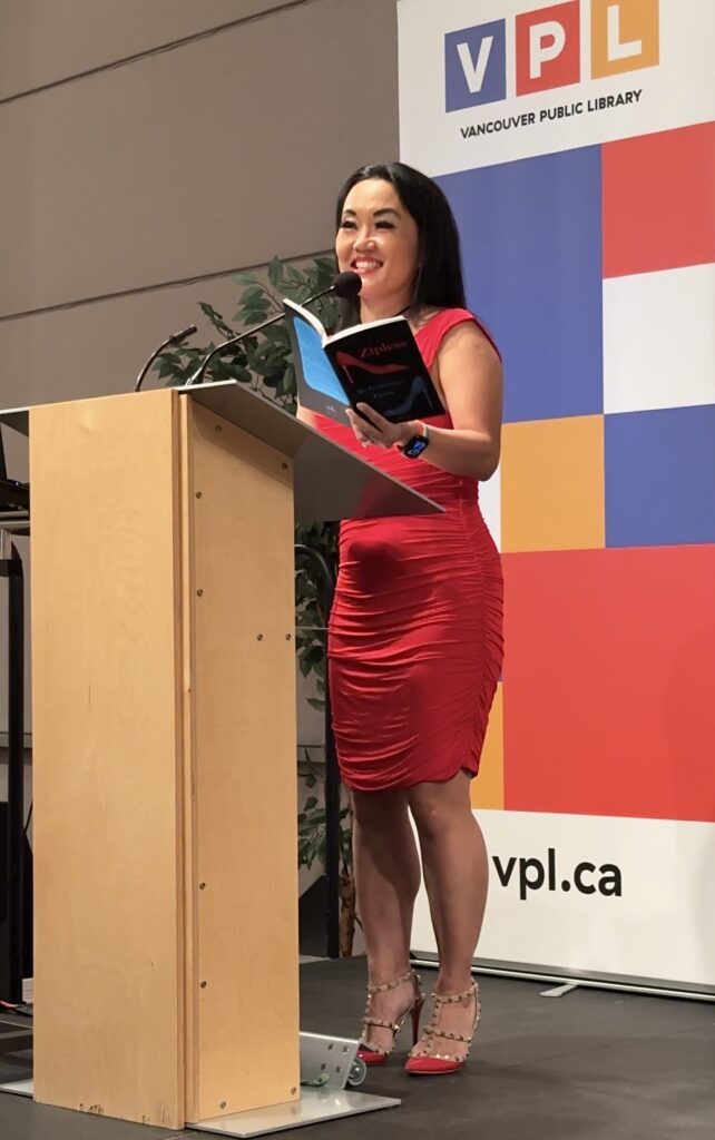 Catherine Lewis reading from ZIPLESS in front of Vancouver Public Library banner